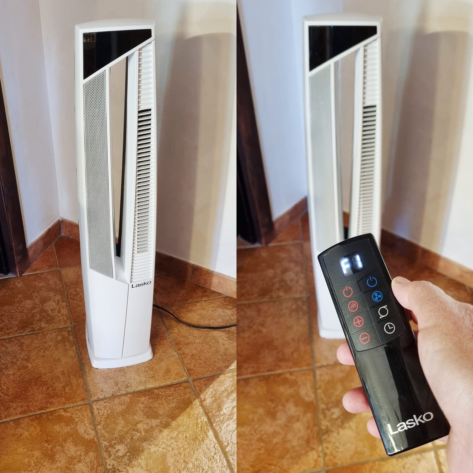 A sleek white tower fan stands beside a hand holding its remote control, set on a tiled floor in a well-lit indoor space.