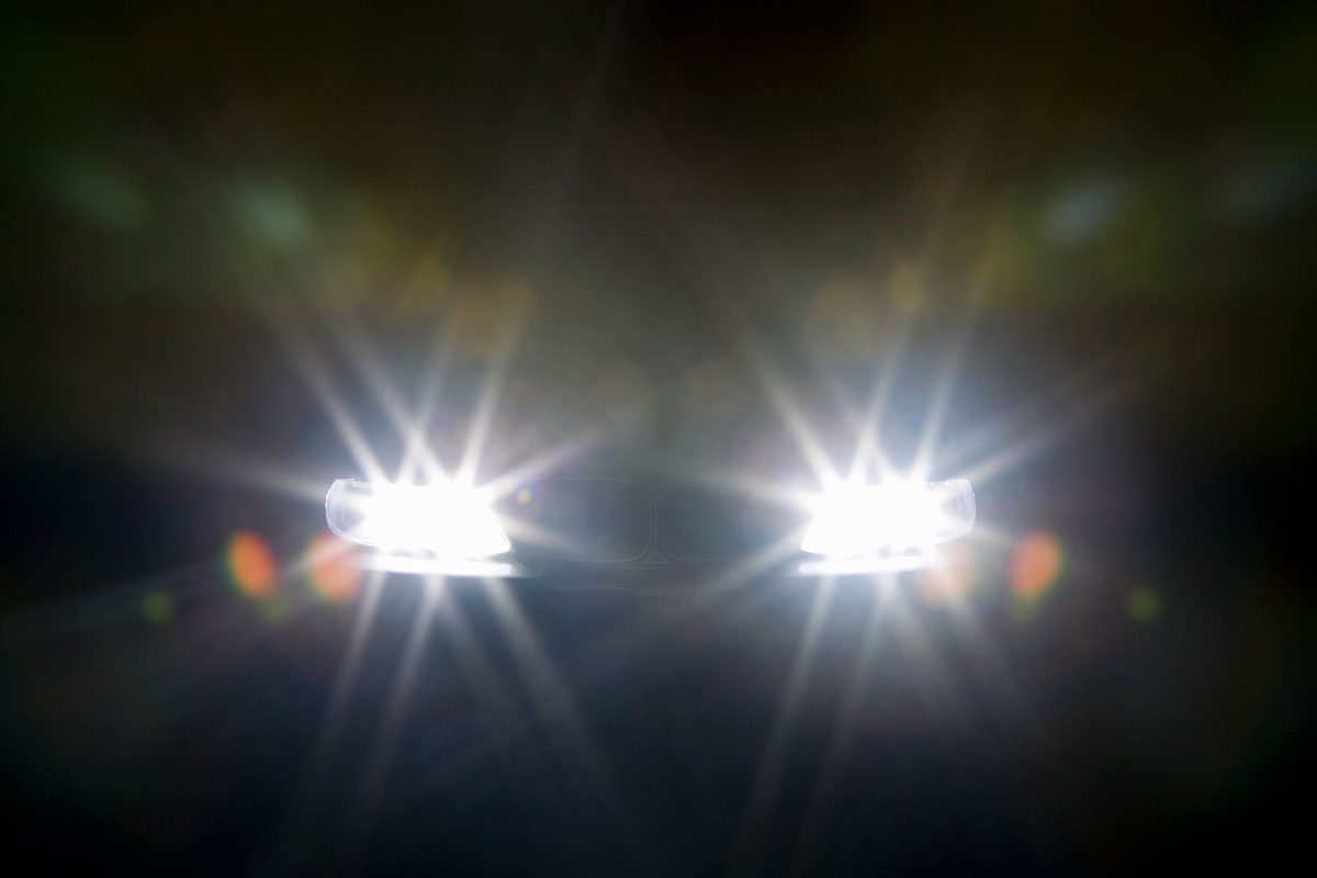 A car headlights illuminated at night