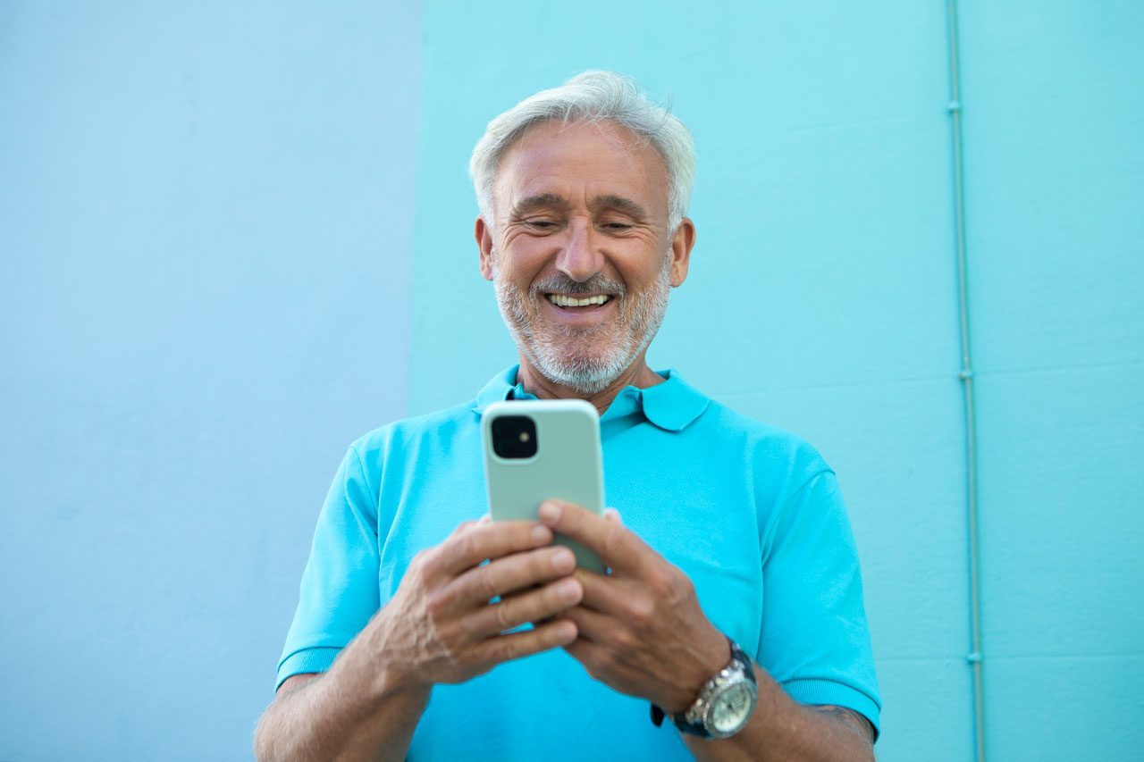 Cheerful mature man using a smart phone