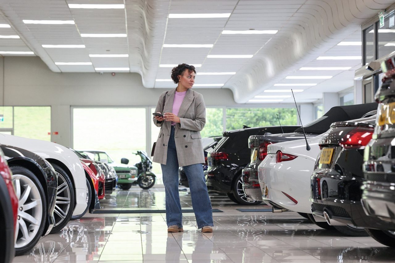 woman in a car showroom