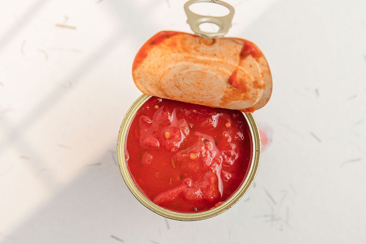 Opened can of arrabbiata sauce, or sugo all'arrabbiata with tomato cubes