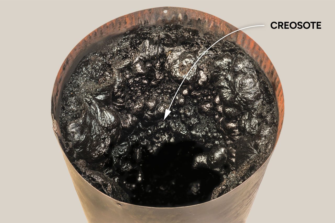Dangerous accumulation of Creosote in a Wood Stove Chimney Pipe.