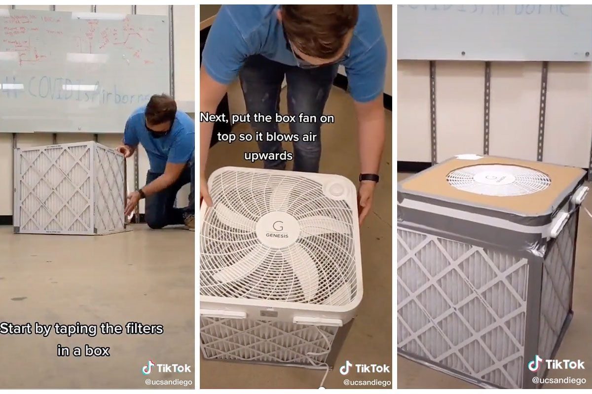 A person assembles a homemade air filter by taping filters inside a box and placing a fan on top to blow air upwards.