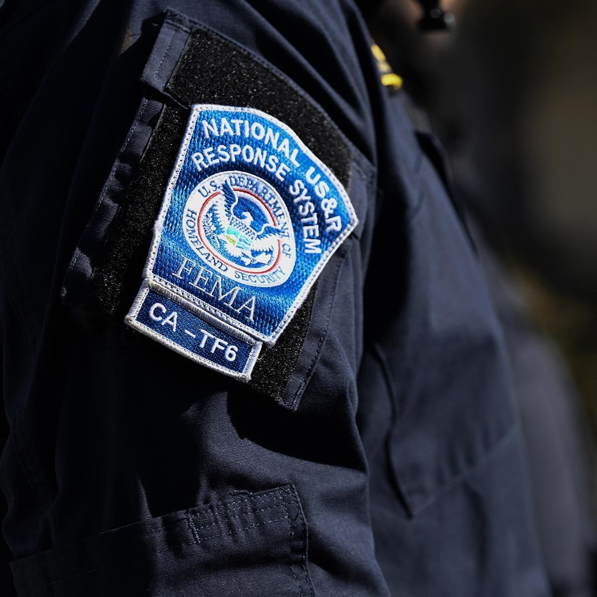 Patch that says "National US&R Response System - FEMA" on a black uniform with the FEMA logo