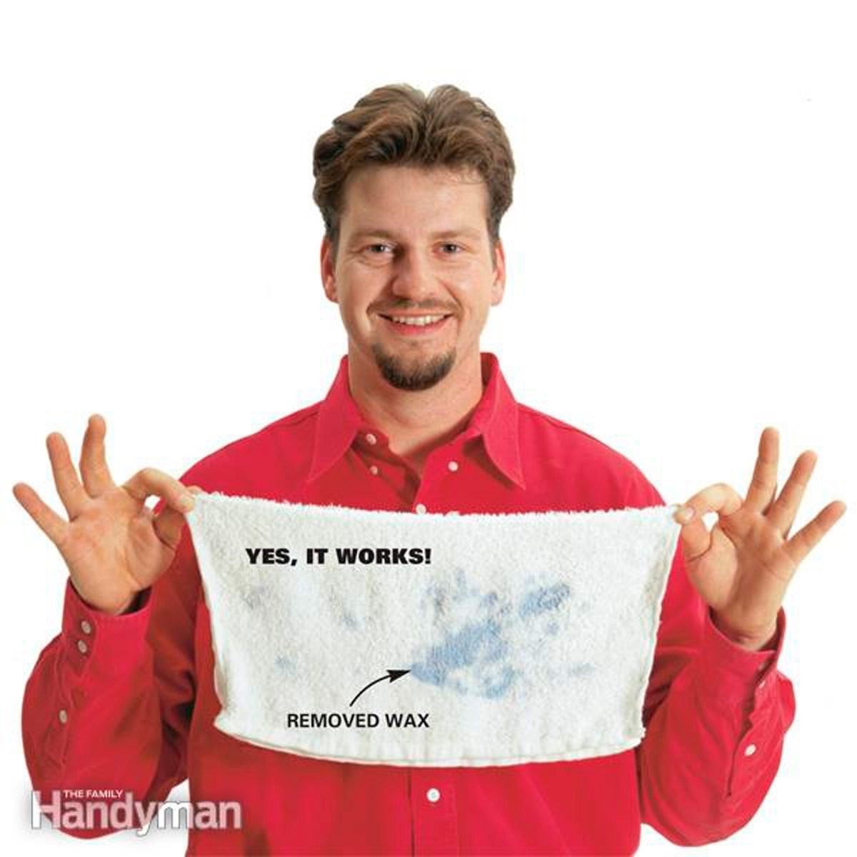 A man smiles while holding a towel displaying a wax mark and text. He gestures positively, suggesting effectiveness in wax removal.