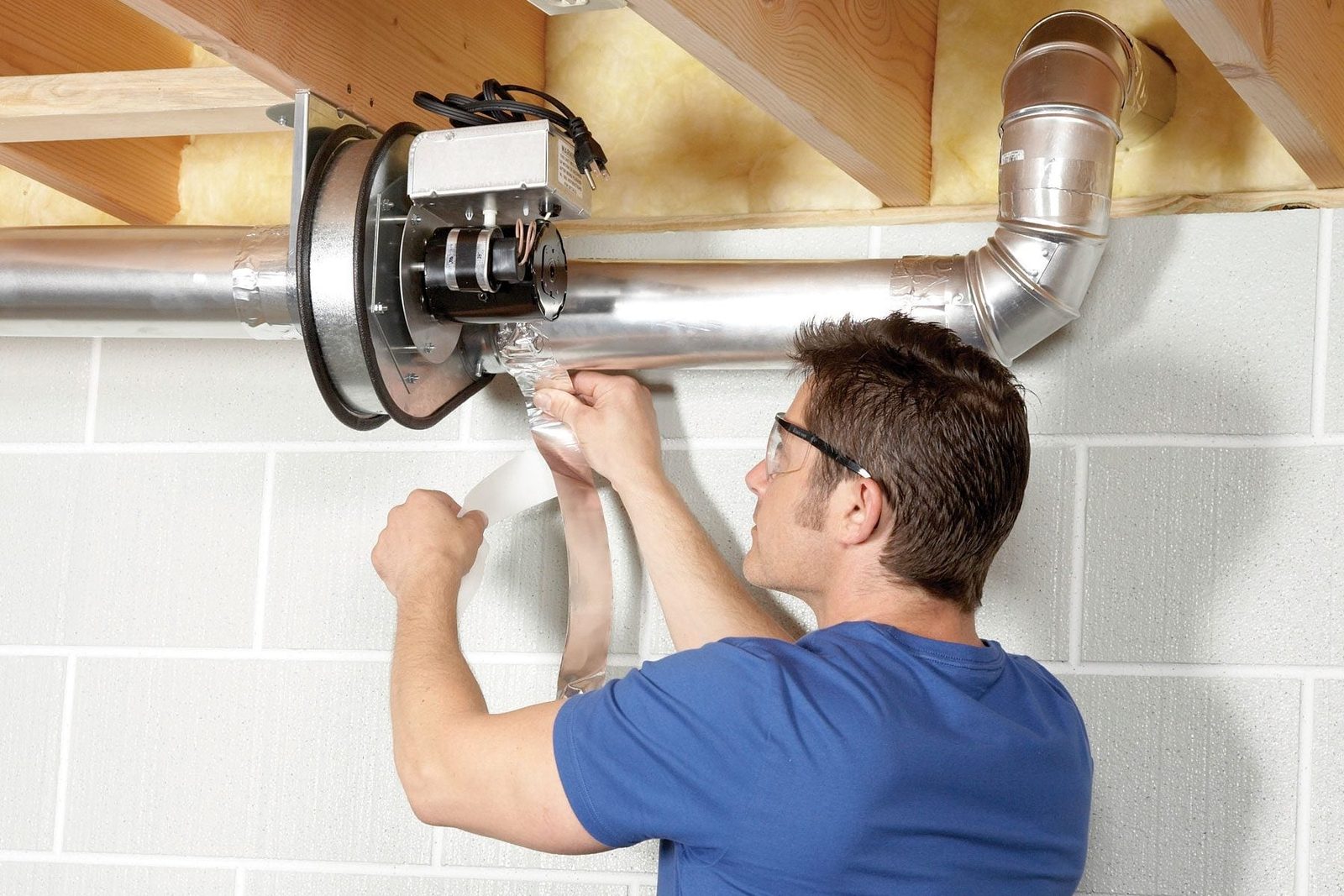 man installing dryer vent fan
