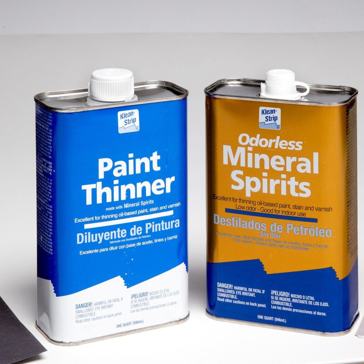 Two metal containers labeled "Paint Thinner" and "Odorless Mineral Spirits" sit side by side, used for thinning oil-based paints and varnish