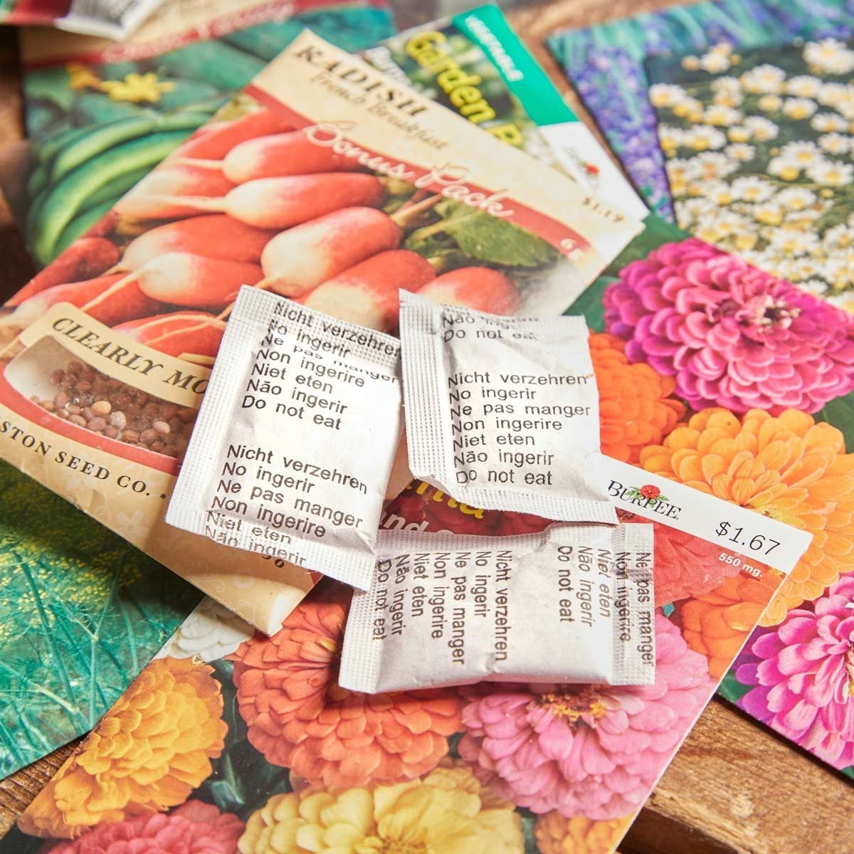 Seed packets lay on a colorful floral background, while a radish seed packet is prominently displayed, indicating planting materials for gar
