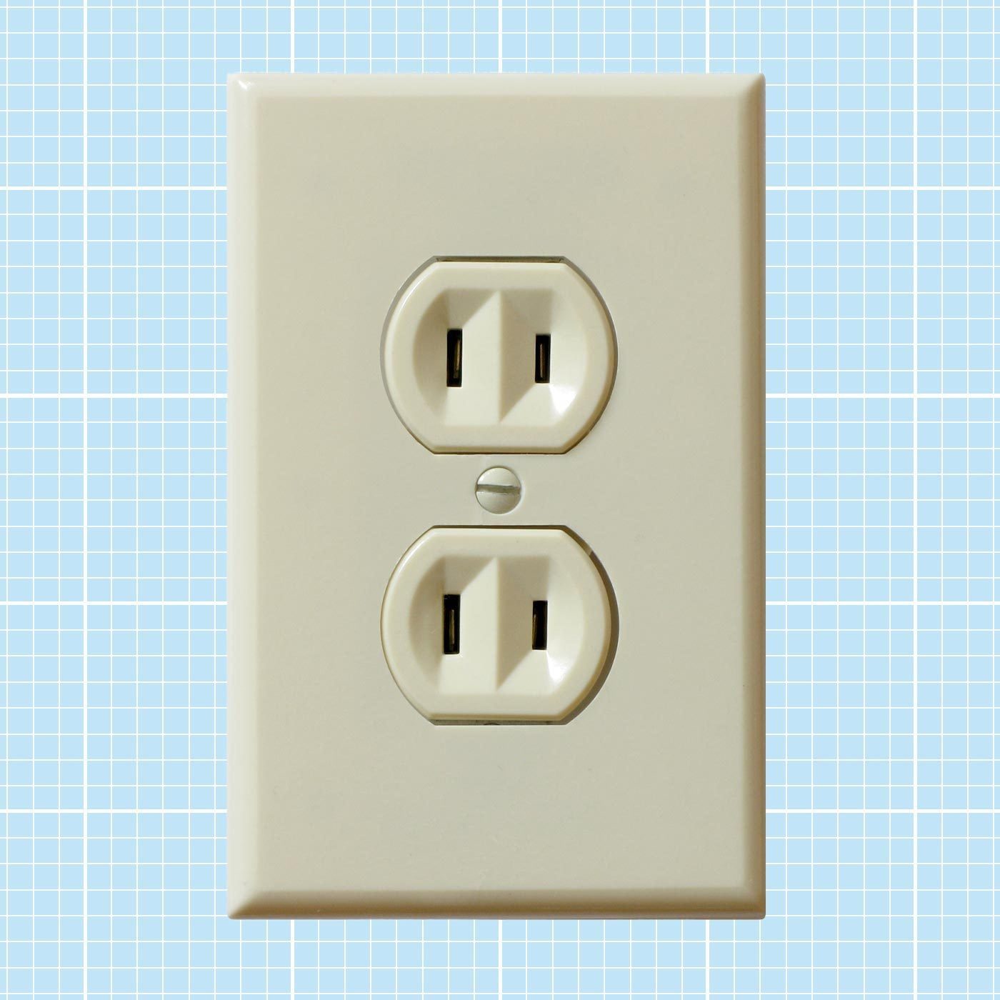 A beige electrical outlet is mounted on a light blue grid-patterned wall, showcasing two receptacles for plugging in devices.