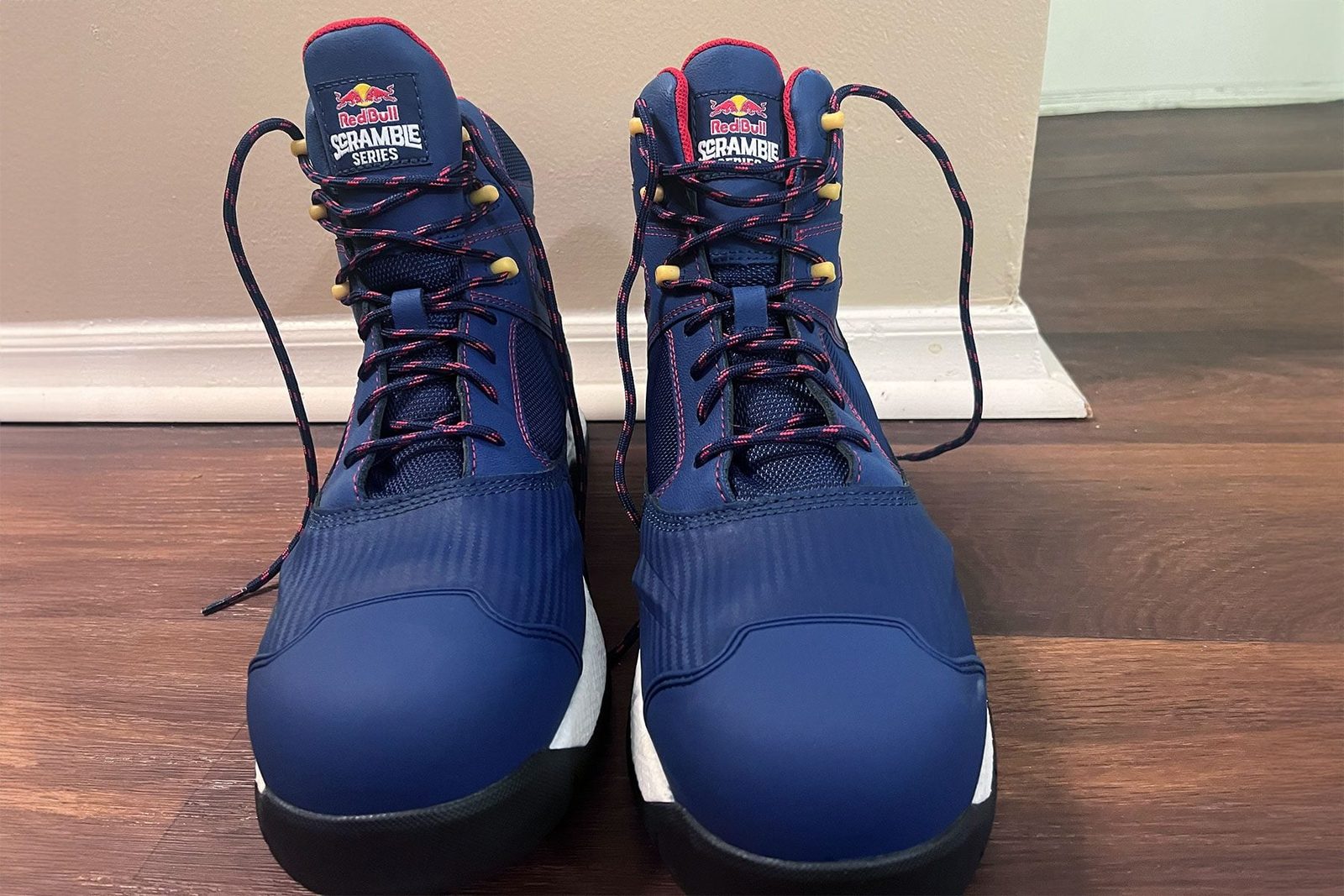 Wolverine Hiking Boots Get A Red Bull Themed Makeover on wooden surface