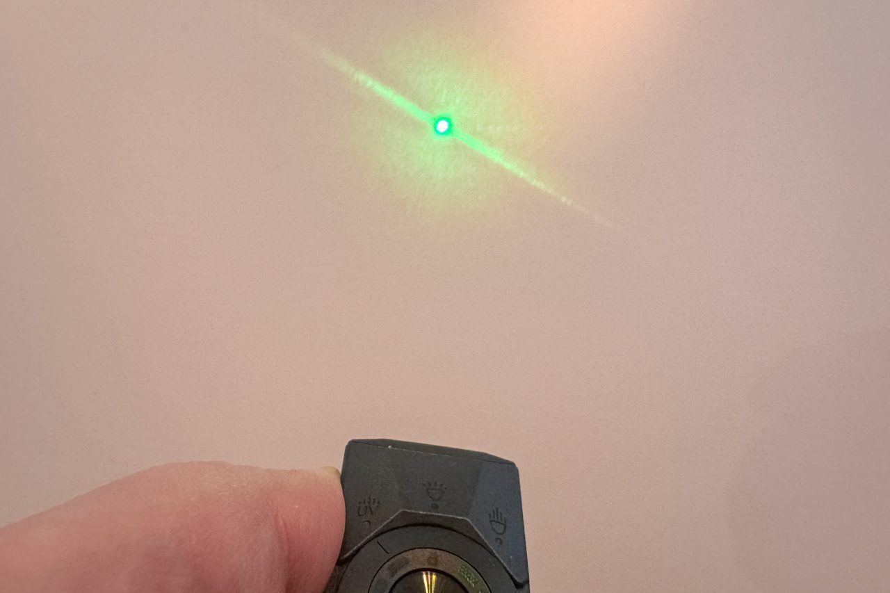 Olight Arkpro Ultra being used as a green laser