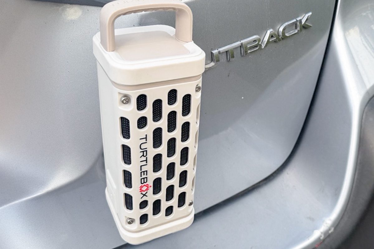 close up of Turtlebox Ranger stuck with magnetic mounts behind a car