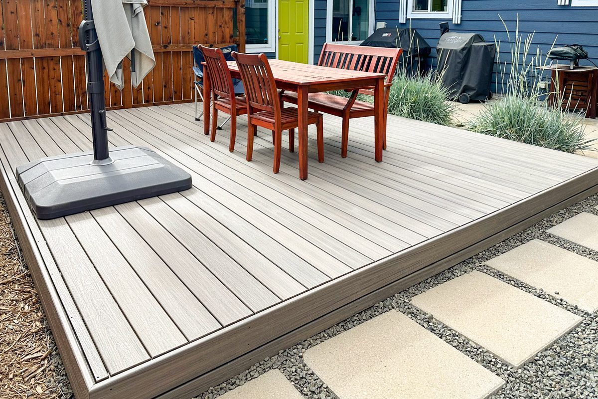 chairs and a table on finished deck in backyard