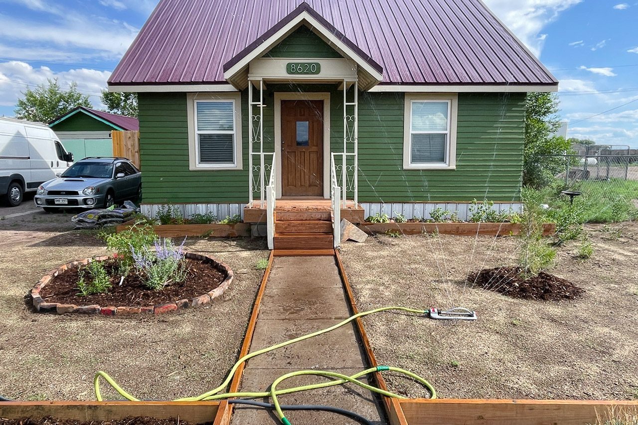 sprinkler watering the front yard of house
