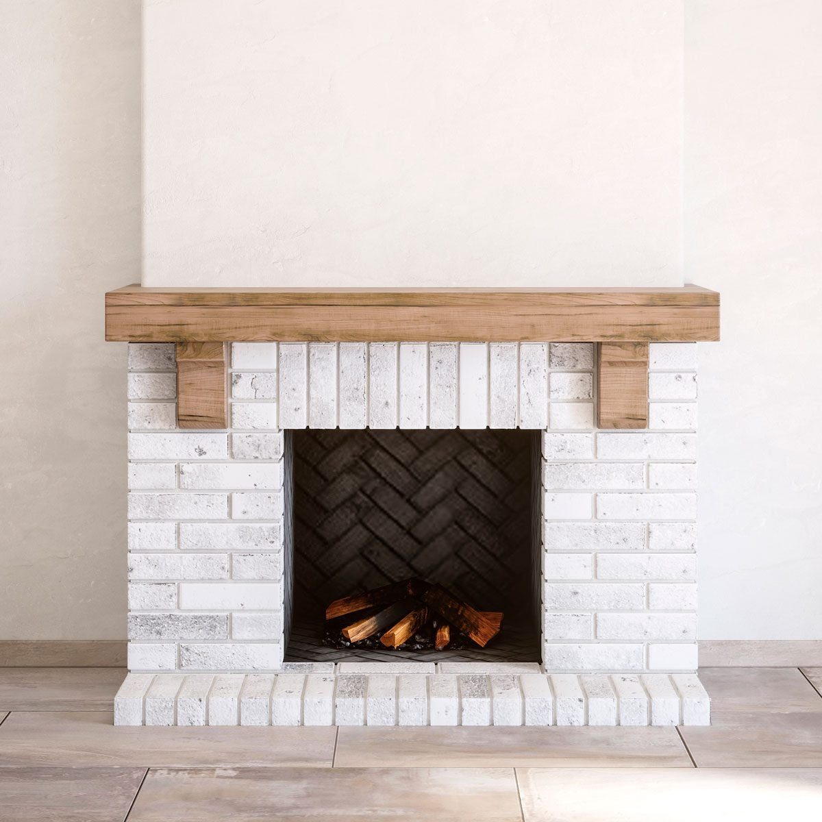 A brick fireplace with a wooden mantle sits in a minimalist, light-colored room, showcasing a neatly arranged pile of logs in the dark inter
