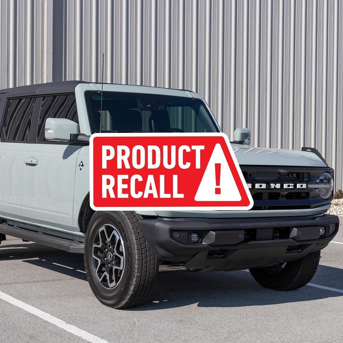 Gray Ford Bronco parked in a parking space with a red "product recall" sticker overlaid