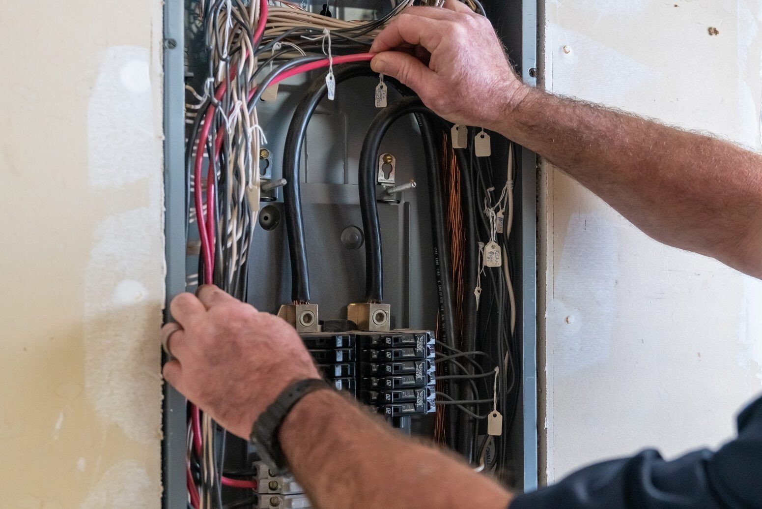 Electrician working on circuit breaker box