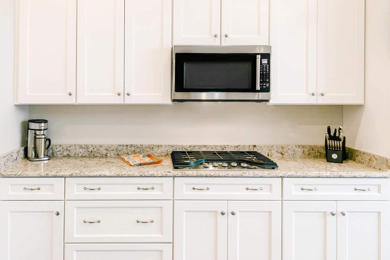 white kitchen cabinets with microwave