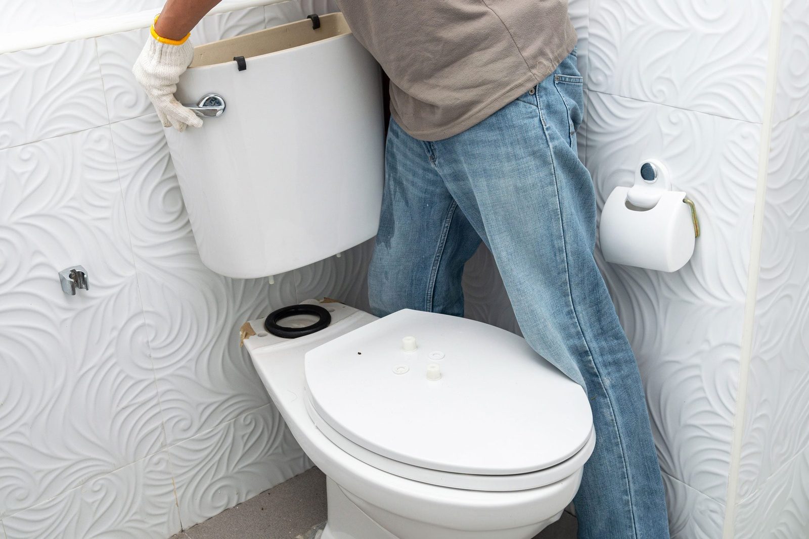 man installing toilet