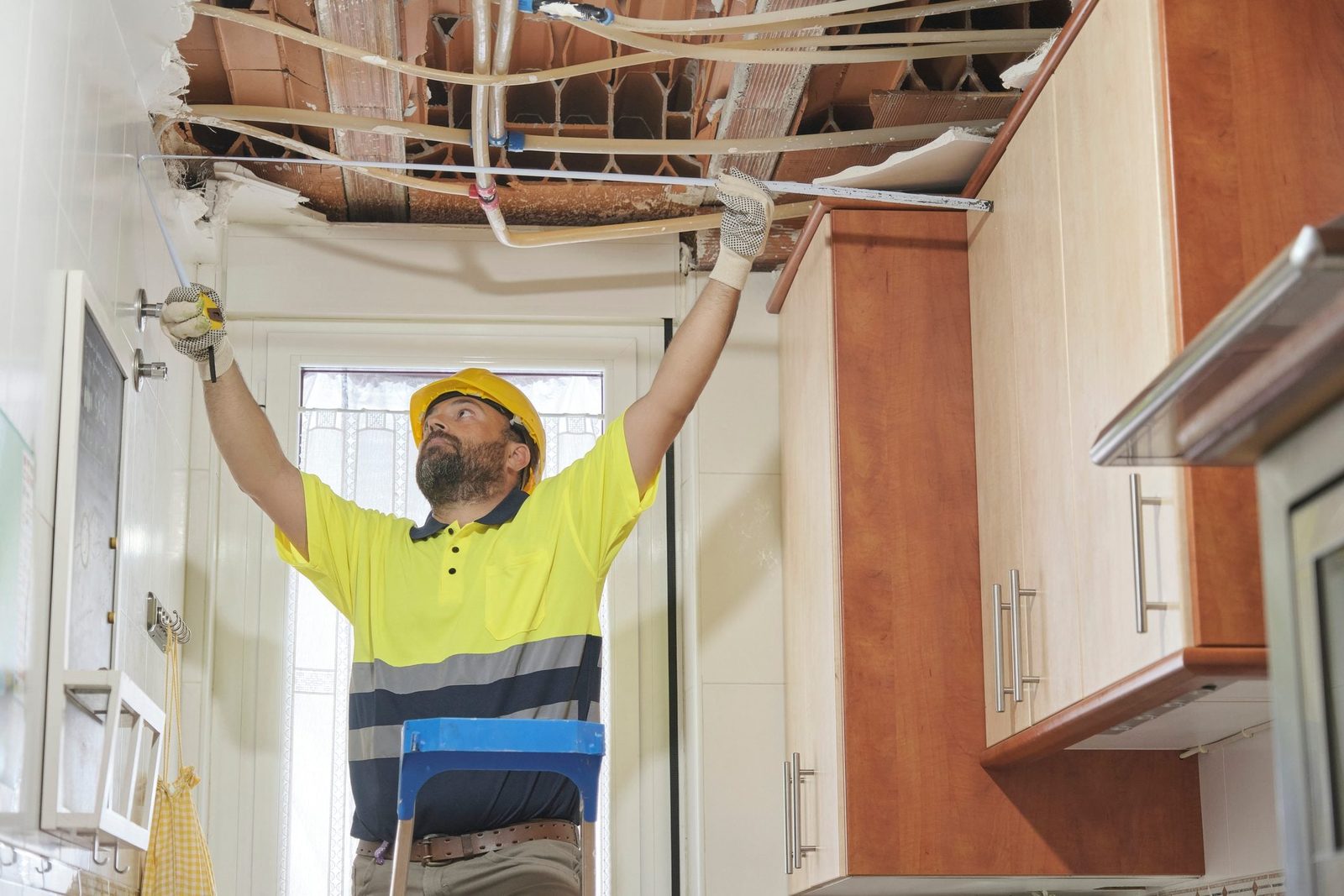 Construction worker inspecting area after natural disaster