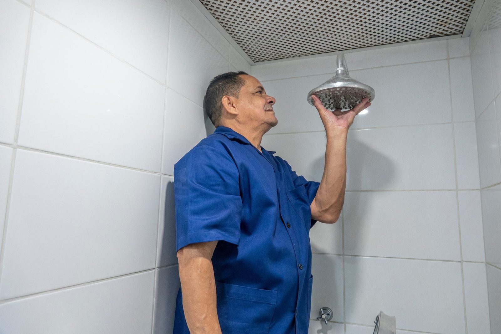 Plumber fixing an apartment shower