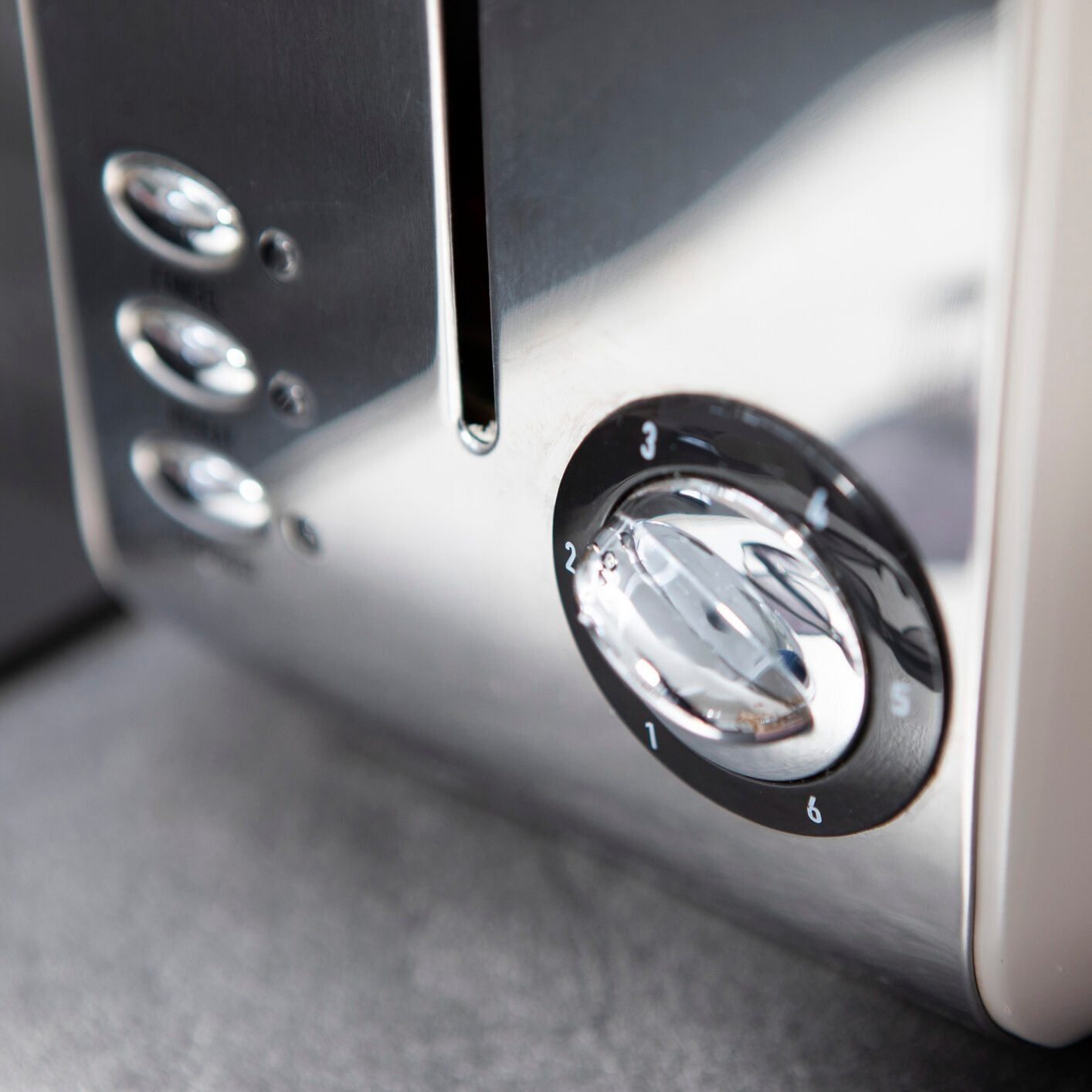 Close-up of the dial and buttons on a toaster