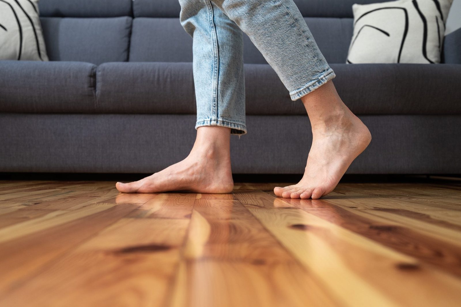 cropped shot of woman walking barefoot in room