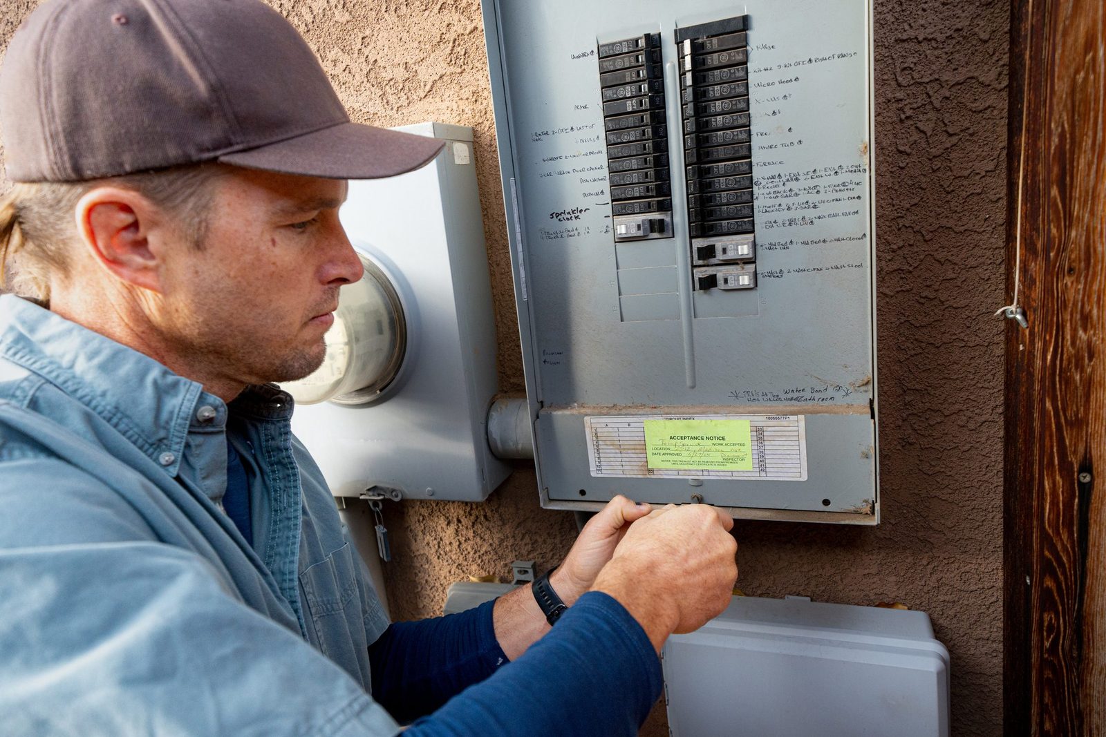 Property Inspector Photographing an Electrical Panel on a Residential Home