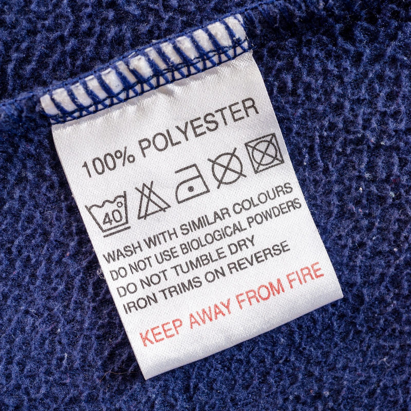 A fabric care label is displayed, providing washing instructions and precautions. It highlights the material as 100% polyester and emphasize