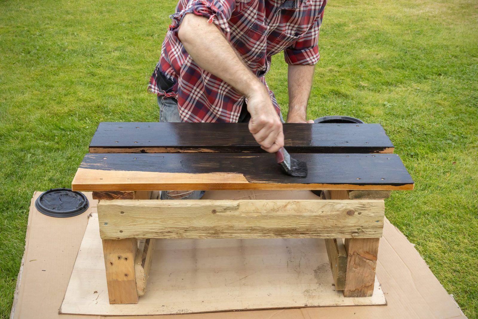 Man painting a garden bench