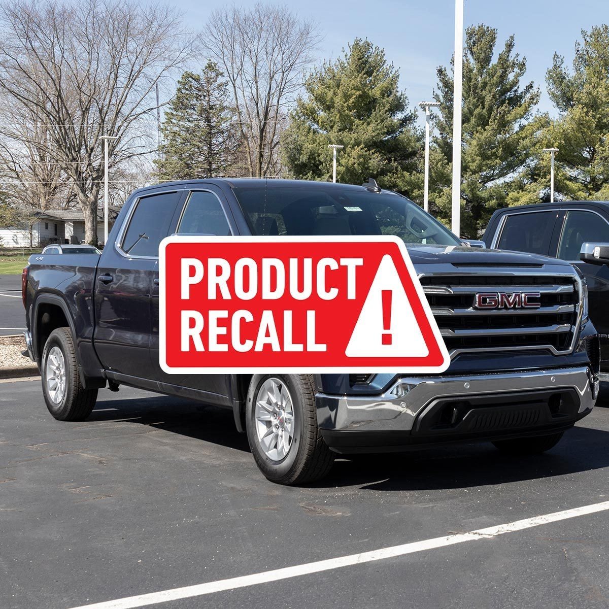 Black 2022 GMC Sierra 1500 in a parking lot with a red "product recall" sticker overlaid