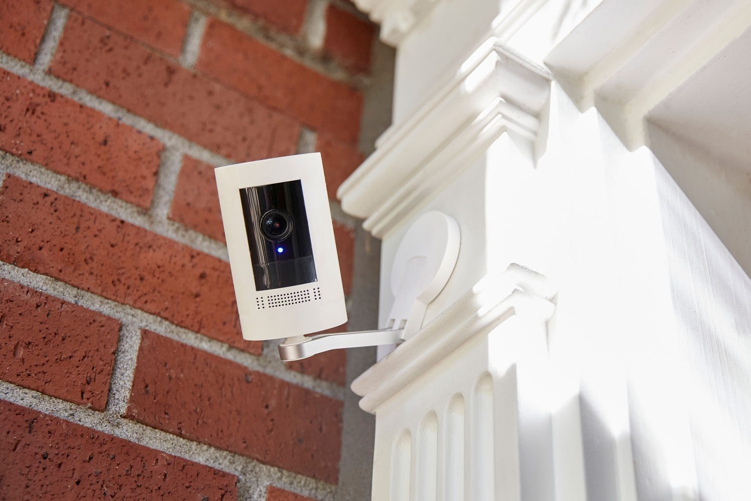 a home security camera attached to the exterior of a home