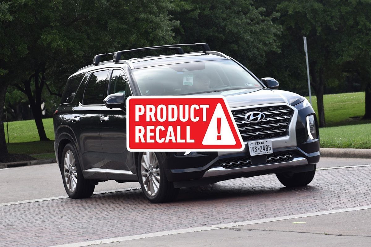 Black Hyundai Palisades SUV driving in a parking lot with a red "product recall" overlay