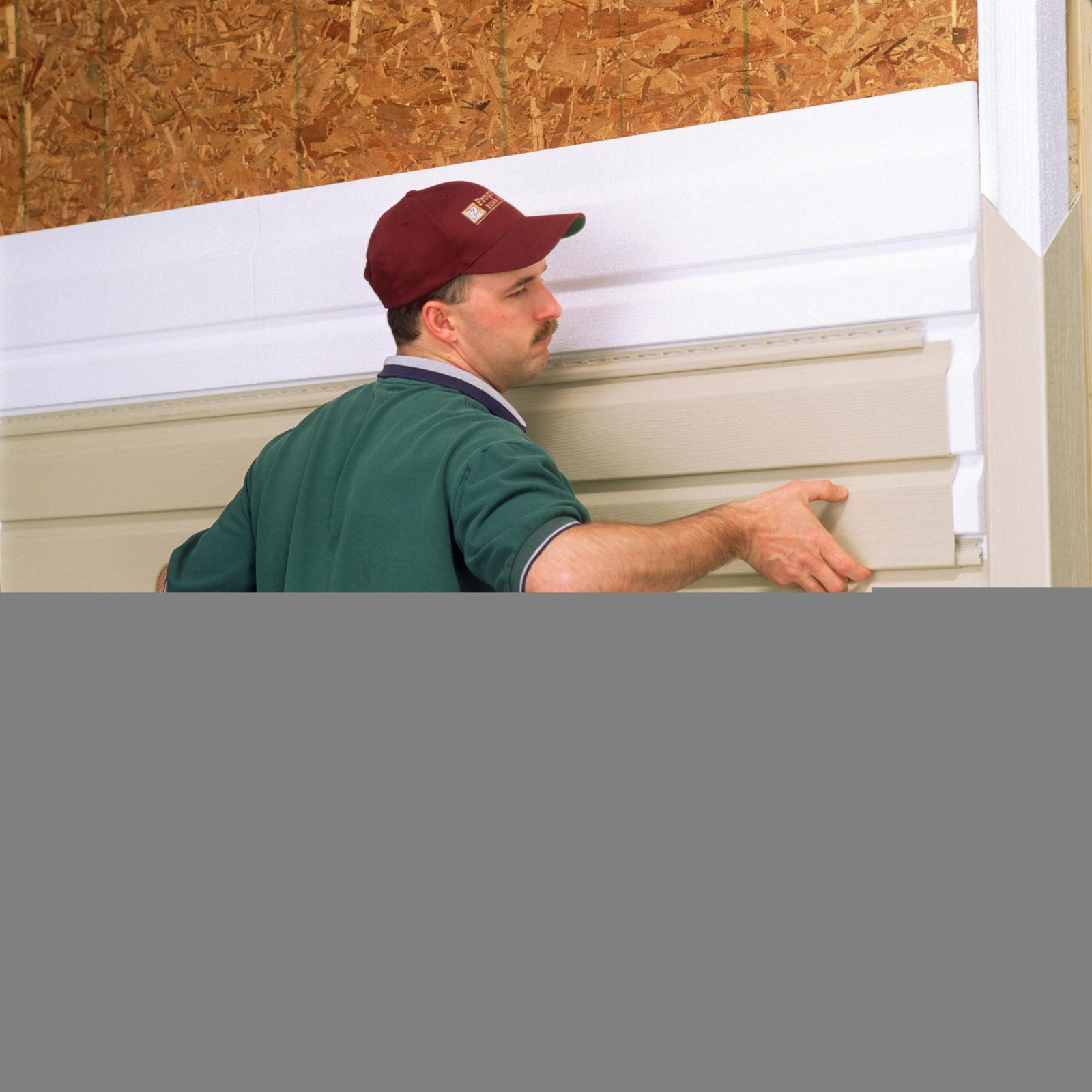 Man installing insulated siding