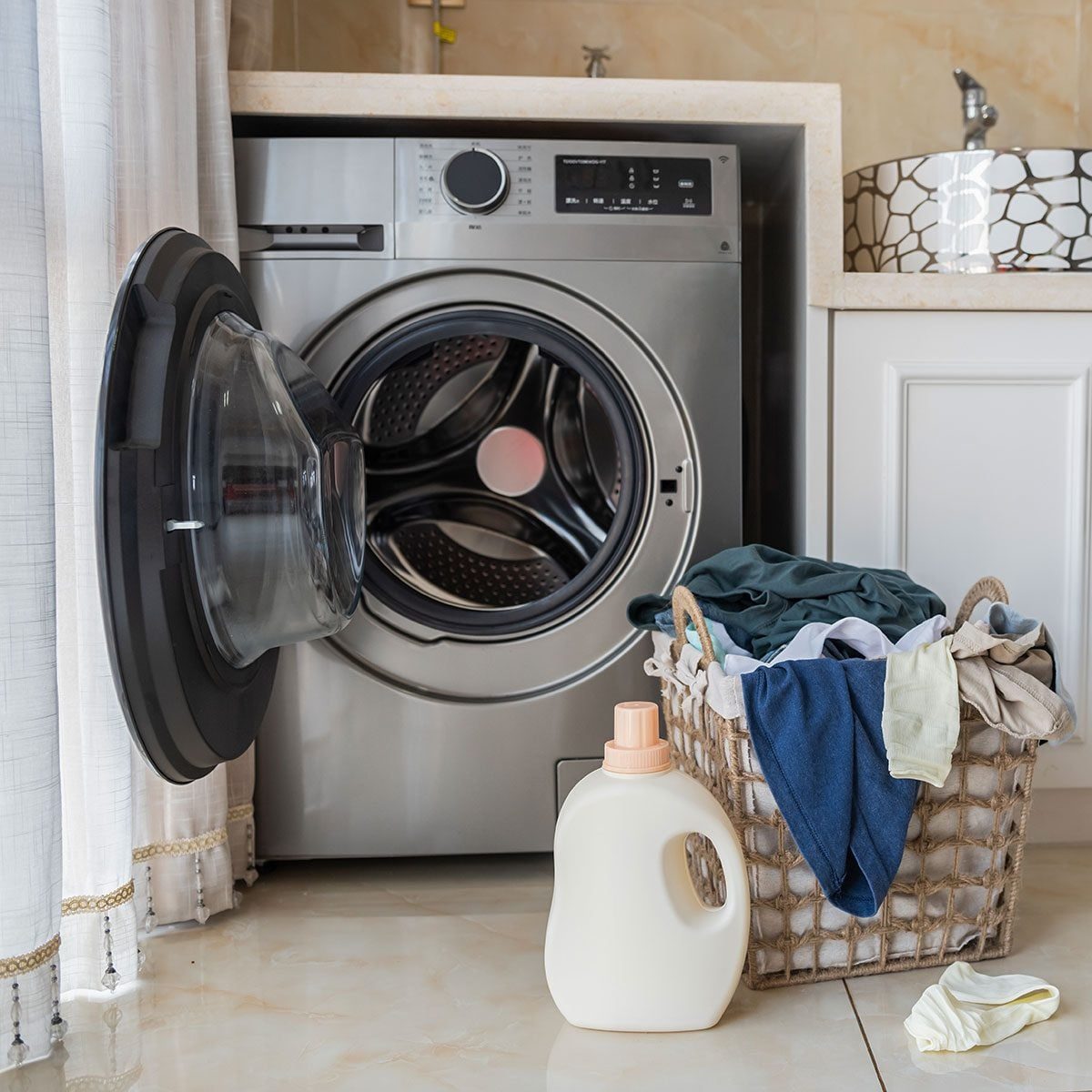 Basket with laundry and washing machine