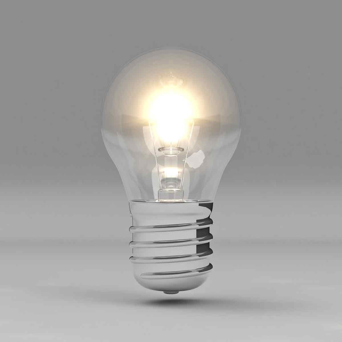 A glowing light bulb emits bright light, suspended against a smooth gray background, highlighting its transparent glass and metallic base.
