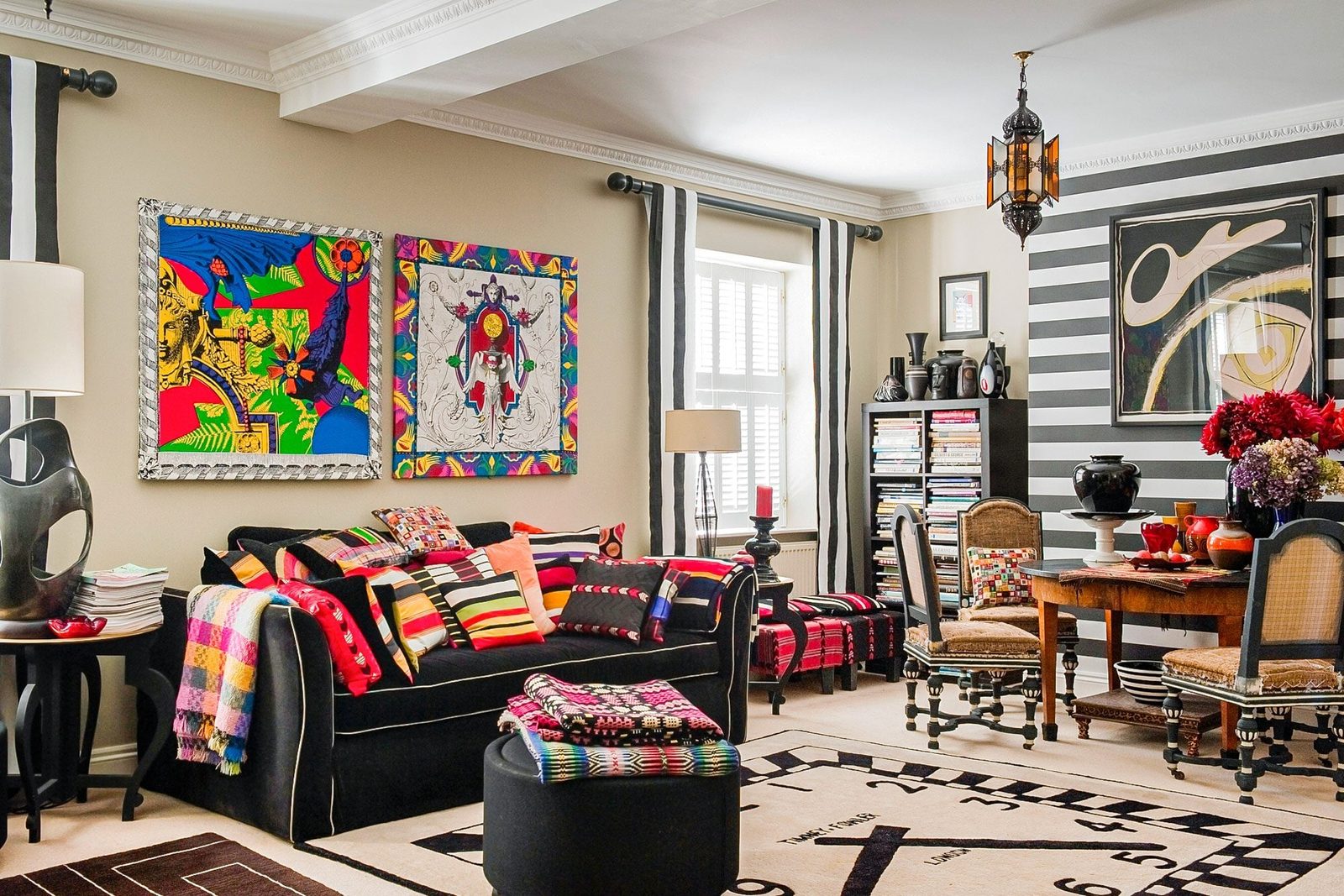 Maximalist Interior Design Timney Fowler Cushions Piled High On A Black Sofa In A Living Room With A Sue Timney Clock Face Rug