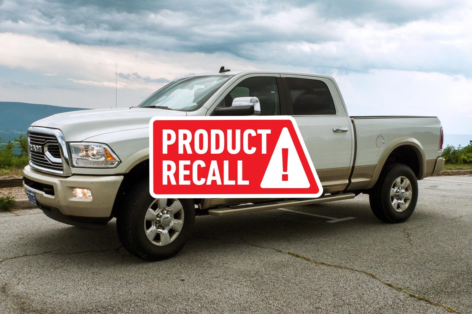 Product Recall sticker over A 2017 RAM 2500 Pickup Truck that Sits on Asphalt in front of a Cloudy Sky