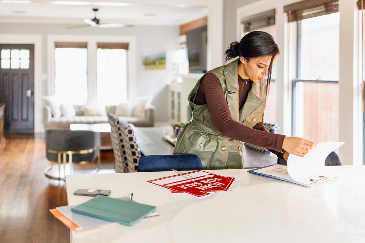 Real Estate Agent Checking A Real Estate List Before Clients Coming