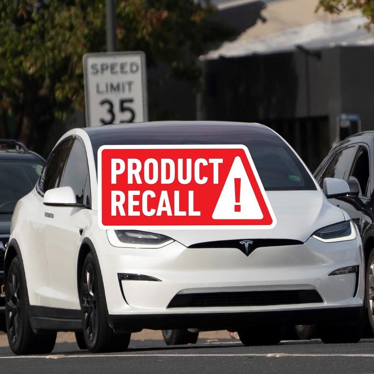 White 2023 Tesla Model Y with a speed limit sign in the background