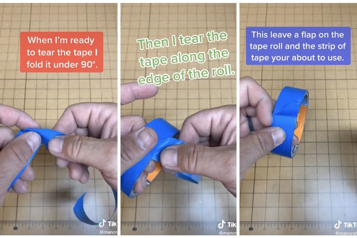 A person tears blue tape by folding it, pulling it along the roll’s edge, and creating a flap for easier use, on a grid-patterned background
