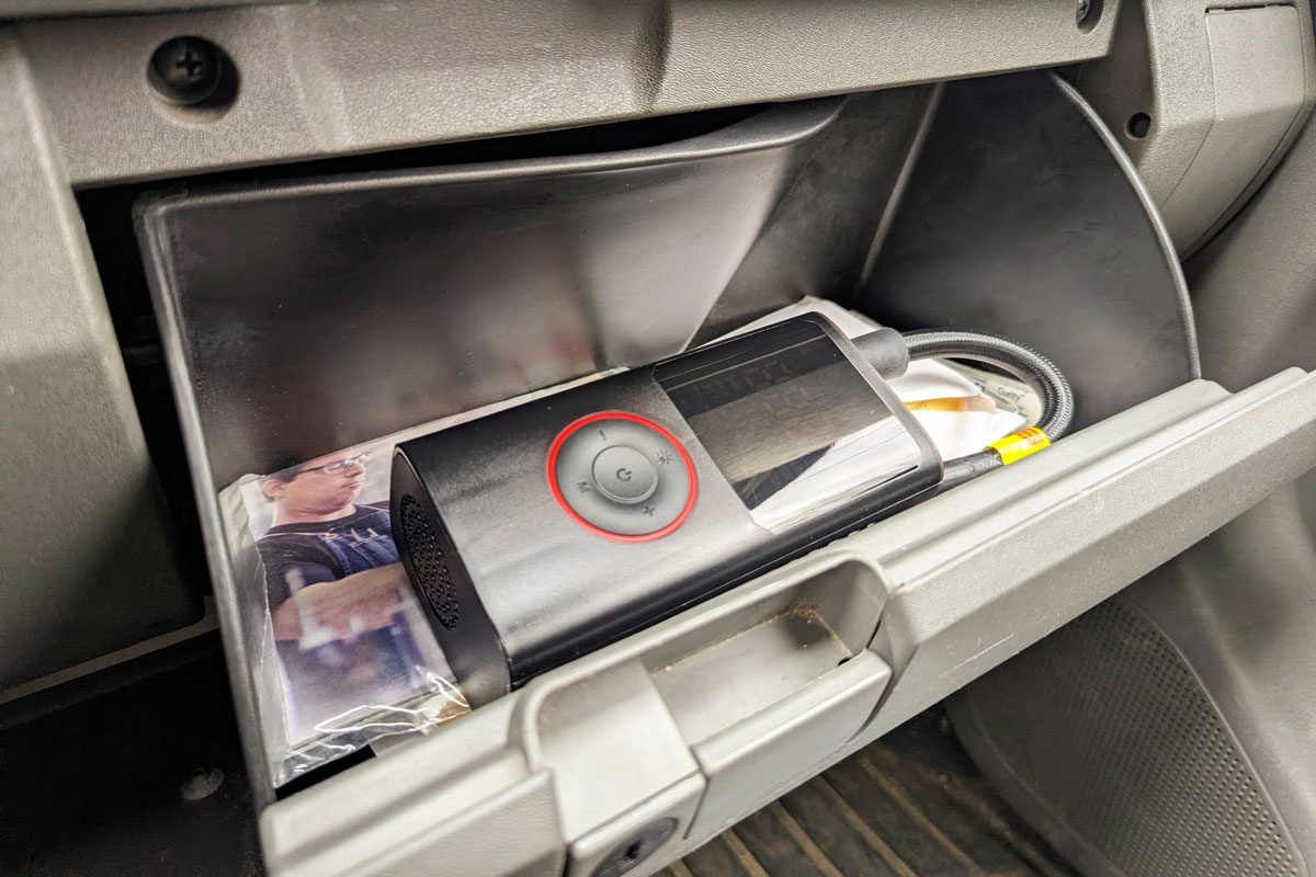 Powools Portable Tire Inflator fits in the glove box, shown open