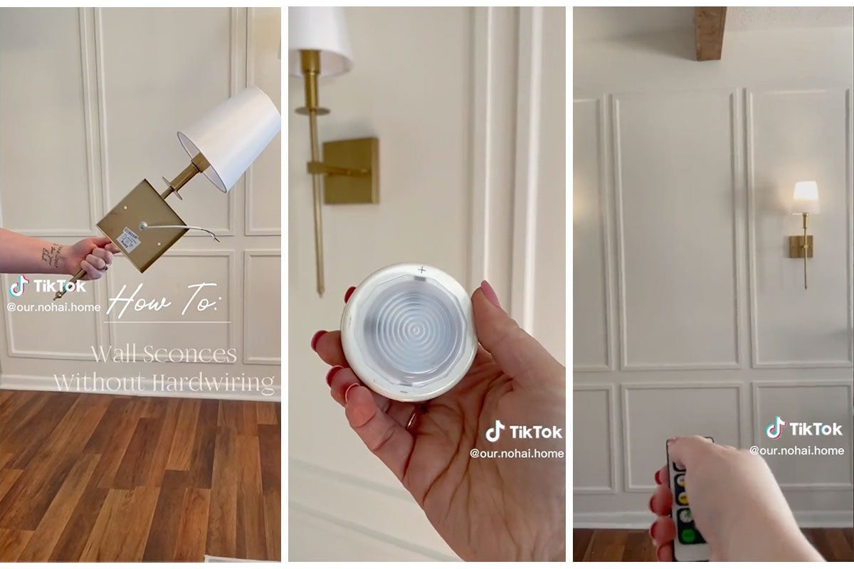 A hand holds a wall sconce, while a remote controls its light on a textured wall in a well-lit room with wooden flooring.