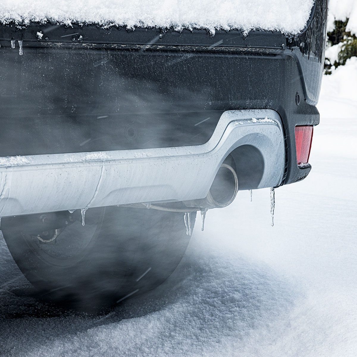 Close-Up of Internal Combustion Engine Car Exhaust on Snowy Winter Day