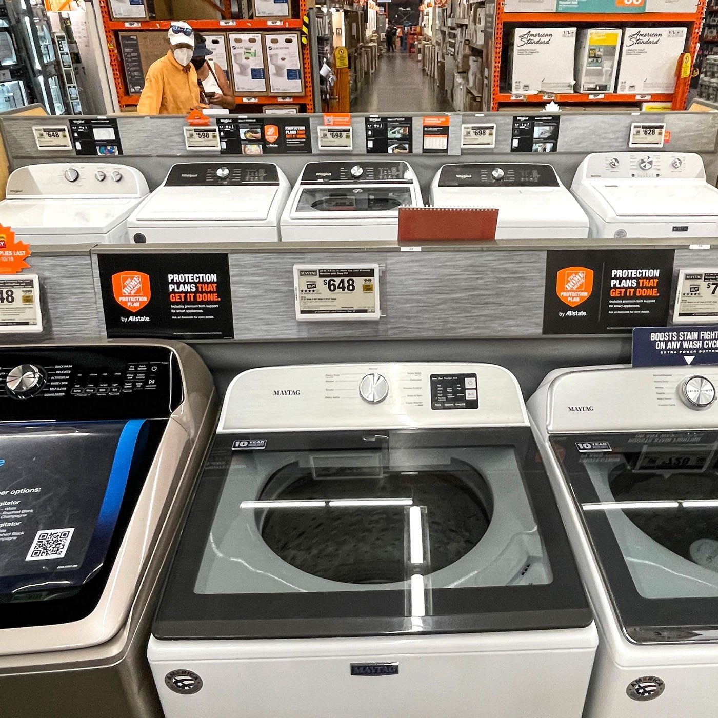A man looking at Appliances to buy in a store