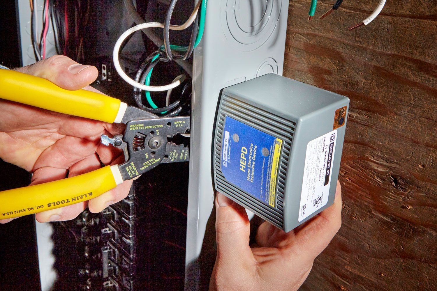 Whole House Surge Protector being attached to a circuit breaker panel in a home