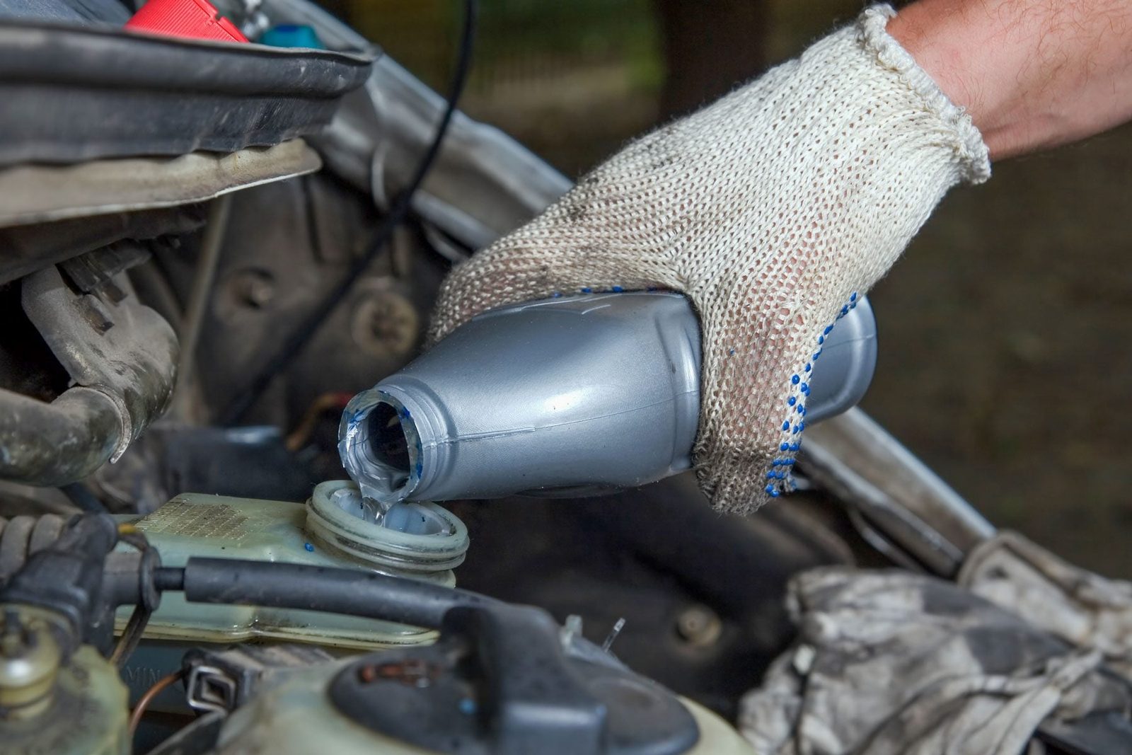 A man pouring Brake Fluid