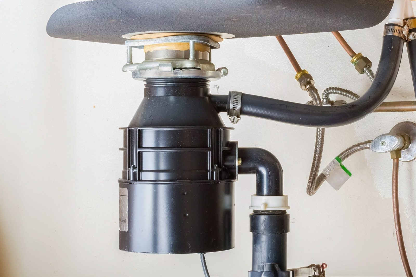 Under the sink garbage disposal unit.