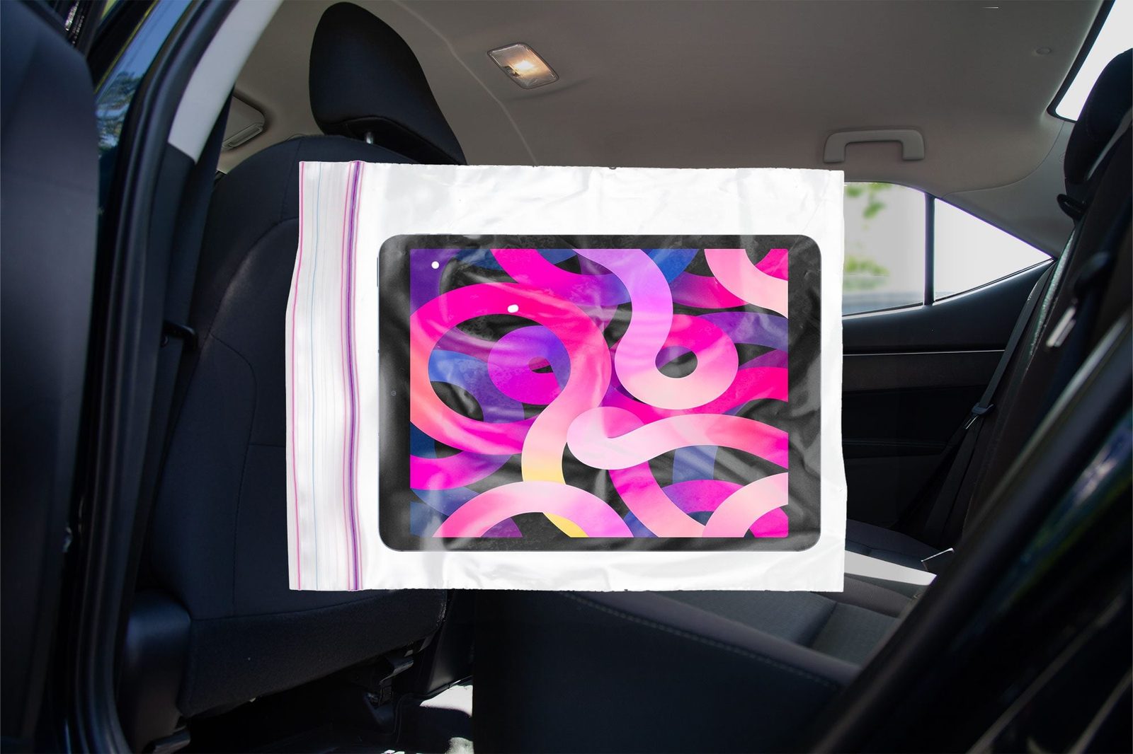 Ipad in a ziploc bag overlay with a car interior background
