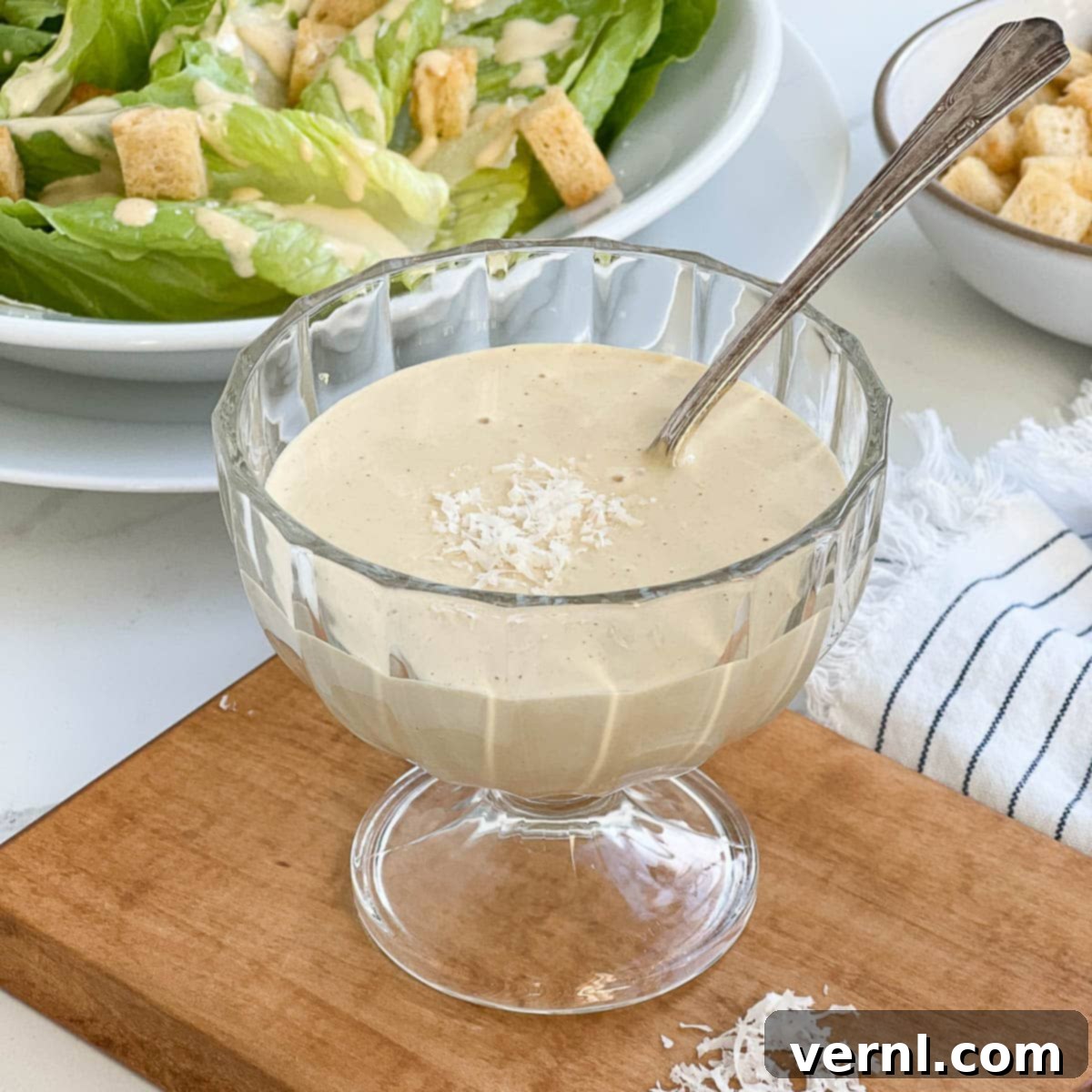 Σαλάτα Ζυμαρικών Καίσαρα με Κοτόπουλο 8 A bowl of homemade caesar dressing with spoon.